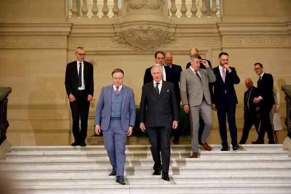 Belgium's King Philippe, center front, and new Belgian Prime Minister Bart De Wever, front center left, walk with ministers after a swearing in ceremony for the new government at the Royal Palace in Brussels, Monday, Feb. 3, 2025. (AP Photo/Omar Havana)