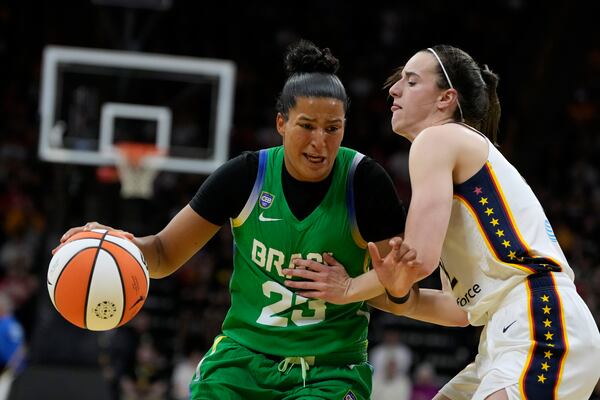 Brazil guard Izabela Leite (23) drives past Indiana Fever guard Caitlin Clark, right, during the first half of an exhibition women's basketball game, Sunday, May 4, 2025, in Iowa City, Iowa. (AP Photo/Charlie Neibergall)