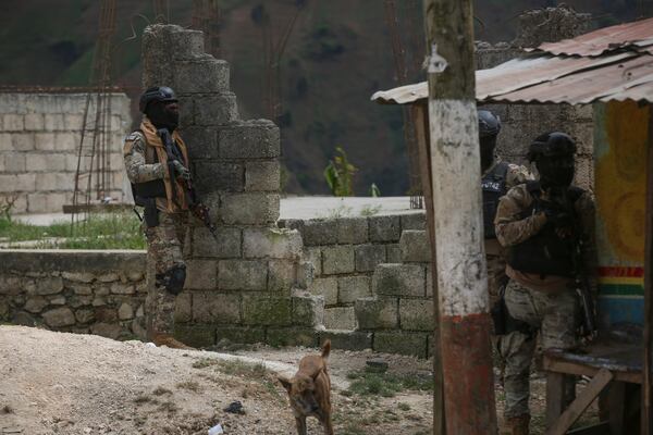 Police officers stand guard during an anti-gang operation in the Kenscoff neighborhood of Port-au-Prince, Haiti, Monday, Feb. 3, 2025. (AP Photo/Odelyn Joseph)