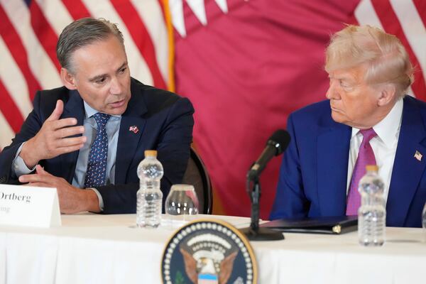 Kelly Ortberg President and CEO of Boeing speaks next to President Donald Trump during a business roundtable, Thursday, May 15, 2025, in Doha, Qatar. (AP Photo/Alex Brandon)