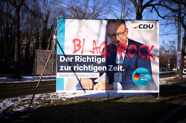 A Christian Democratic Union election poster is smeared with the world Blackrock, a reference to Merz's former employer, in Berlin, Germany, Thursday, Feb. 20, 2025. (AP Photo/Markus Schreiber)