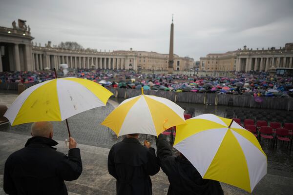 Participants in a mass for the jubilar pilgrims from Naples wait for the start of the celebration under pouring rain in St. Peter's Square at The Vatican, Saturday, March 22, 2025. (AP Photo/Andrew Medichini)