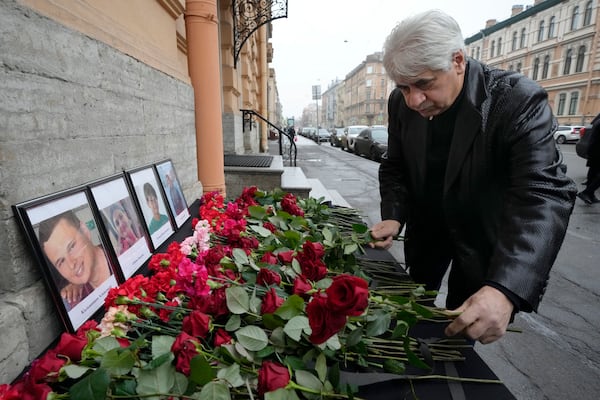 The head of the Azerbaijani diaspora in St. Petersburg Vagif Mamishev lays flowers at the Consulate of Azerbaijan in St. Petersburg, Russia, Thursday, Dec. 26, 2024, in memory of victims of the Azerbaijan Airlines' Embraer 190 that crashed near the Kazakhstan's airport of Aktau. (AP Photo/Dmitri Lovetsky)