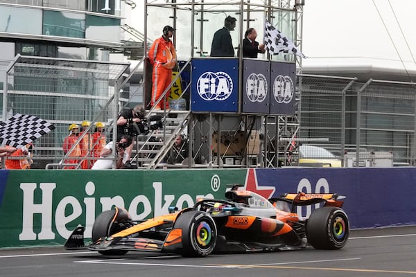 McLaren driver Oscar Piastri of Australia crosses the finish line to win the Chinese Formula One Grand Prix race at the Shanghai International Circuit, Shanghai, Sunday, March 23, 2025. (AP Photo)