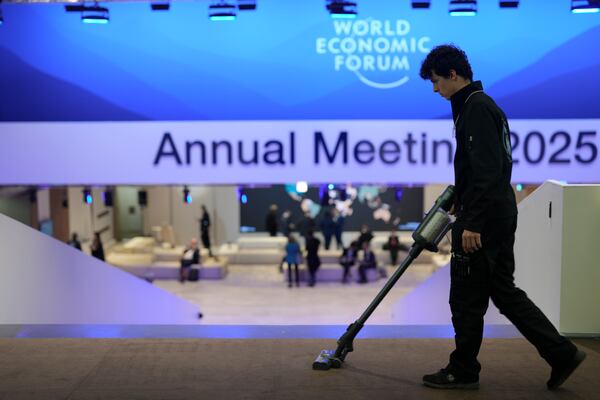 A man cleans the floor at the congress center prior to the official opening of the Annual Meeting of the World Economic Forum in Davos, Switzerland, Monday, Jan. 20, 2025. (AP Photo/Markus Schreiber)