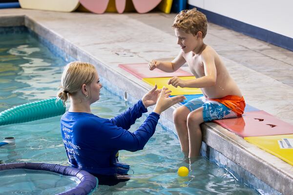 In this handout photo provided by Children's Services Council of Palm Beach County, aquatic educator Riley Taylor helps a student into the water during an autism-specific swim class at Small Fish Big Fish, Tuesday, April 1, 2025 in West Palm Beach, Fla. ((Ben Rusnak /Children's Services Council of Palm Beach County via AP)