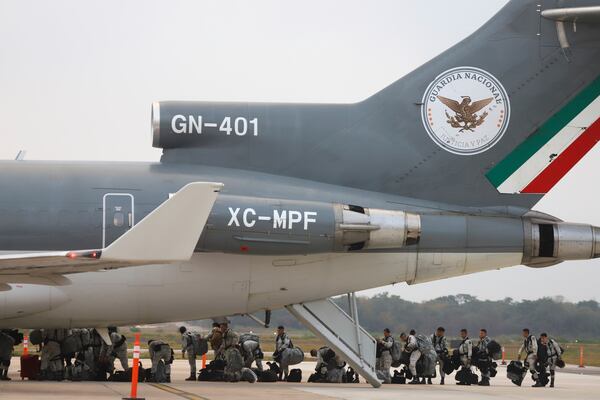 Mexican National Guards board an aircraft at the International Airport in Merida, Mexico, Tuesday, Feb. 4, 2025, to reinforce the country's northern border with the United States. (AP Photo/Martin Zetina)