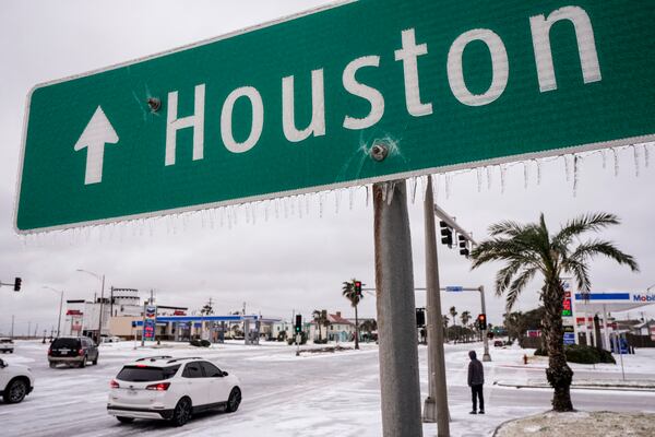 Icicles hang from a sign pointing the way to Houston during an icy winter storm on Tuesday, Jan. 21, 2025 in Galveston, Texas. (Brett Coomer/Houston Chronicle via AP)