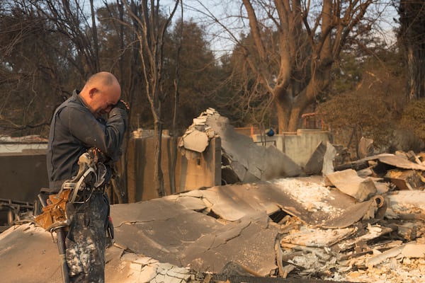 Cesar Plaza becomes emotional while looking at his home destroyed by the Eaton Fire in Altadena, Calif., Thursday, Jan. 9, 2025. (AP Photo/Nic Coury)