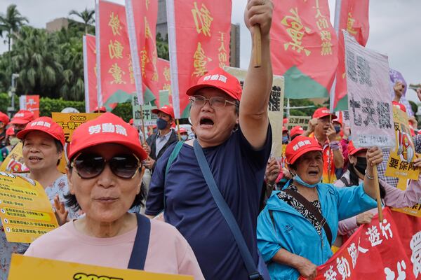 Taiwanese workers shout slogans during a May Day rally in Taipei, Taiwan, Thursday, May 1, 2025. (AP Photo/Chiang Ying-ying)