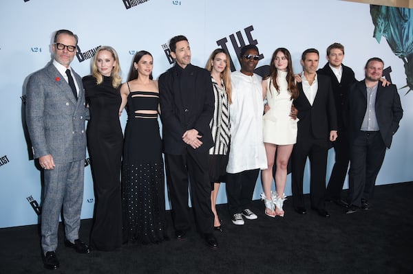 Guy Pearce, from left, Mona Fastvold, Felicity Jones, Adrien Brody, Stacy Martin, Isaach de Bankole, Raffey Cassidy, Alessandro Nivola, Joe Alwyn, and Brady Corbet arrive at the premiere of "The Brutalist" on Thursday, Dec. 5, 2024, at Vista Theatre in Los Angeles. (Photo by Richard Shotwell/Invision/AP)