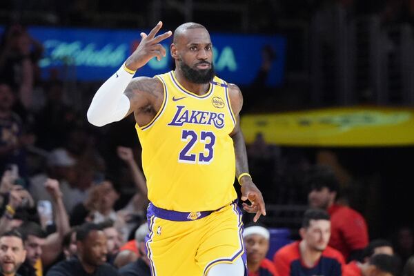 Los Angeles Lakers forward LeBron James gestures after making a 3-point basket to go over the 50,000 career point mark during the first half of an NBA basketball game against the New Orleans Pelicans, Tuesday, March 4, 2025, in Los Angeles. (AP Photo/Jae C. Hong)