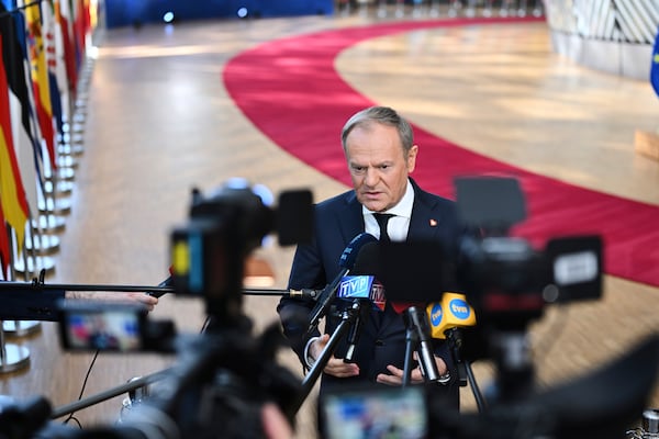 Poland's Prime Minister Donald Tusk speaks with the media as he arrives for an EU Summit at the European Council building in Brussels, Thursday, March 6, 2025. (AP Photo/Harry Nakos)