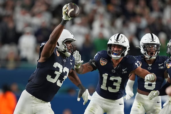 Penn State defensive end Dani Dennis-Sutton (33) celebrates after intercepting a pass during the second half of the Orange Bowl College Football Playoff semifinal game against Notre Dame, Thursday, Jan. 9, 2025, in Miami Gardens, Fla. (AP Photo/Rebecca Blackwell)