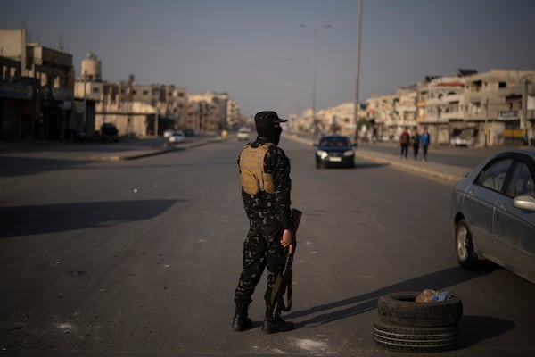 A member of the security forces of the newly formed Syrian government stands on guard at a security checkpoint in Homs, Syria, Thursday, Dec. 26, 2024. (AP Photo/Leo Correa)