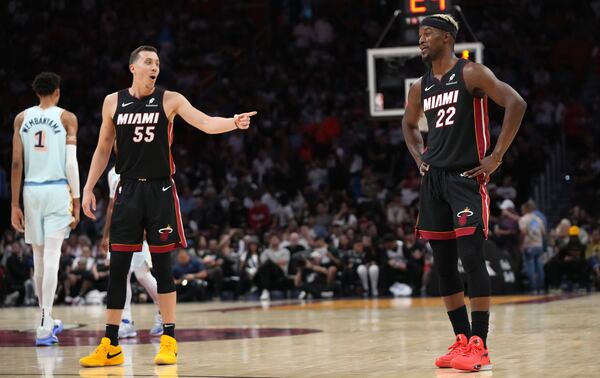 Miami Heat forward Duncan Robinson (55) talks with forward Jimmy Butler (22) during the second half of an NBA basketball game against the San Antonio Spurs, Sunday, Jan. 19, 2025, in Miami. (AP Photo/Lynne Sladky)