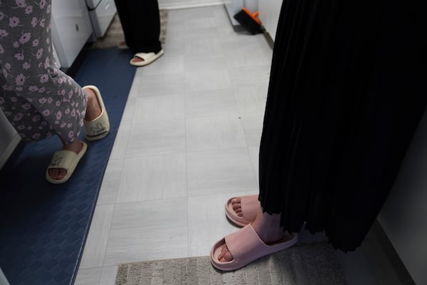 Marjila Badakhsh and her roommates wear sandals while cooking together in their apartment in Alexandria, Va., Wednesday, March 5, 2025. (AP Photo/Jessie Wardarski)