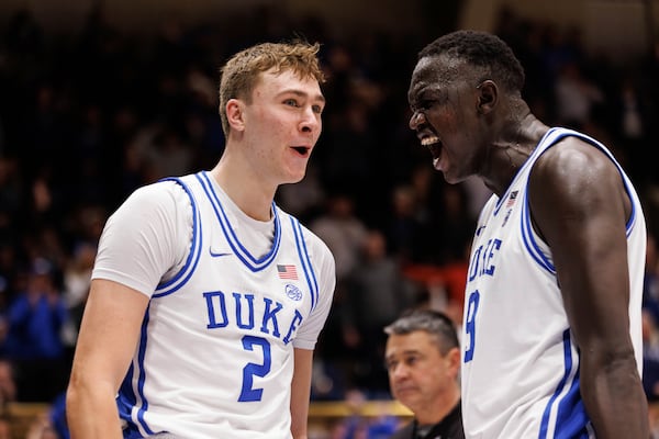 Duke's Cooper Flagg (2) reacts with Khaman Malauch (9) after a dunk during the second half of an NCAA college basketball game agaist Pittsburgh in Durham, N.C., Tuesday, Jan. 7, 2025. (AP Photo/Ben McKeown)