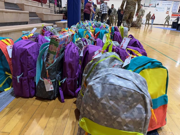 Backpacks filled with gifts wait to be given to children in Yakutat, Alaska, in the Alaska National Guard's Operation Santa program, Wednesday, Dec. 18, 2024. (AP Photo/Mark Thiessen)