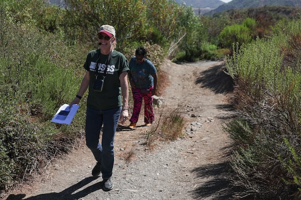 Kate Scharer, a research geologist with the Earthquake Science Center of the US Geological Survey, left, walks with Shirley Jackson, an adjunct professor of general geology at York College, during an accessible field trip to the San Andreas Fault organized by the International Association of Geoscience Diversity Thursday, Sept. 26, 2024, in San Bernadino, Calif. (AP Photo/Ryan Sun)