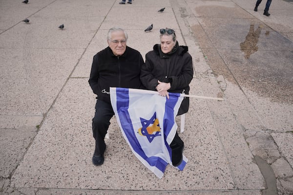 Israelis Shoshi and Dov Peleg wait in the Hostages square for the release of the Israelis kidnapped by Hamas in Gaza, as they begin to gather in Tel Aviv, Israel on Saturday, Feb. 8, 2025. (AP Photo/Oded Balilty)