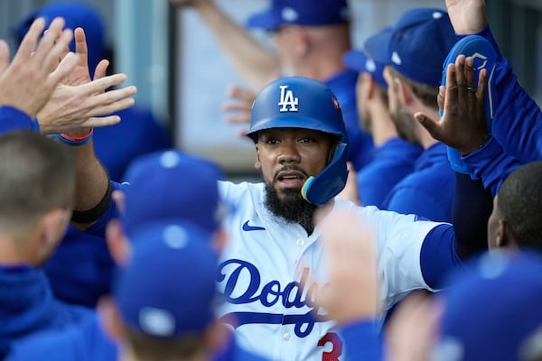 FILE - Los Angeles Dodgers' Teoscar Hernández is high-fived in the dugout after scoring on a sacrifice fly ball by Gavin Lux during the second inning in Game 2 of a baseball NL Division Series against the San Diego Padres, Sunday, Oct. 6, 2024, in Los Angeles. (AP Photo/Ashley Landis, File)