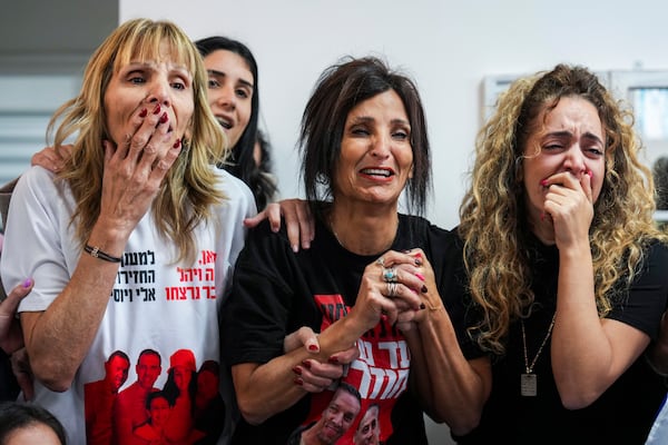 Family of Israeli hostage Eli Sharabi, whose wife and two daughters were killed on Oct. 7 attack, react as they watch the live broadcast of him being released from Hamas captivity in Gaza, in Tel Aviv, Israel, Saturday, Feb. 8, 2025, as part of the Israel-Hamas ceasefire deal. (AP Photo/Ariel Schalit)