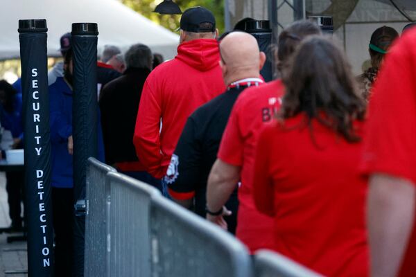 Fans pass through security check points as they enter the Superdome fan zone ahead of the Sugar Bowl NCAA College Football Playoff game, Thursday, Jan. 2, 2025, in New Orleans. (AP Photo/Butch Dill)