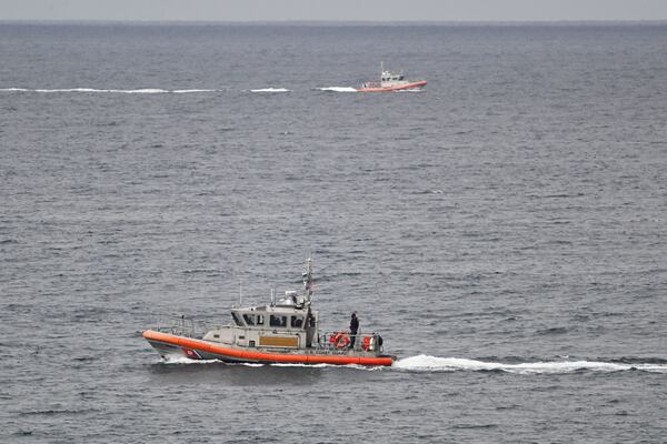 U.S Coast Guard boats look for survivors after a boat capsized in the surf Monday, May 5, 2025, at Torrey Pines State beach in San Diego, Calif. (AP Photo/Denis Poroy)