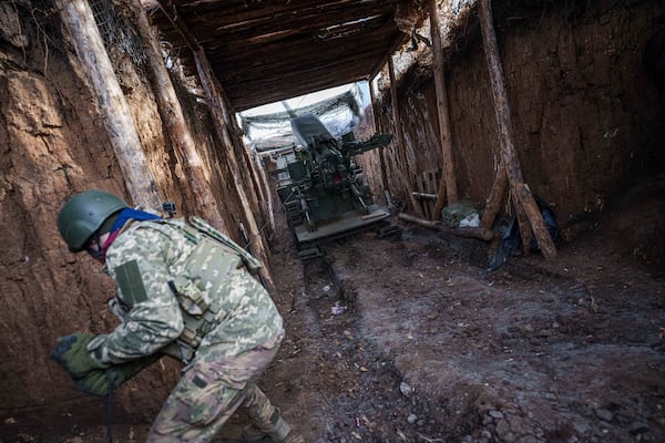 A Ukrainian serviceman of 26th artillery brigade fires by a self-propelled howitzer "Bohdana" towards Russian positions at the frontline in Donetsk region, Ukraine, Wednesday, Jan. 22, 2024. (AP Photo/Evgeniy Maloletka)