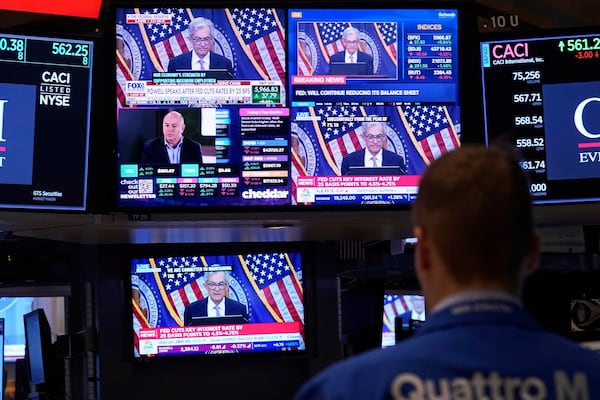 FILE - Comments by Federal Reserve Chair Jerome Powell appear on a bank of screens on the floor of the New York Stock Exchange, Nov. 7, 2024, in New York. (AP Photo/Richard Drew, File)