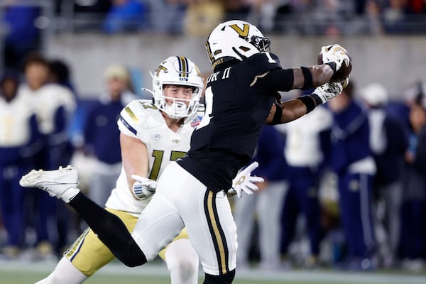 Vanderbilt safety CJ Taylor (1) intercepts a pass intended for Georgia Tech tight end Josh Beetham (17) during the second half of the Birmingham Bowl NCAA college football game, Friday, Dec. 27, 2024, in Birmingham, Ala. (AP Photo/Butch Dill)