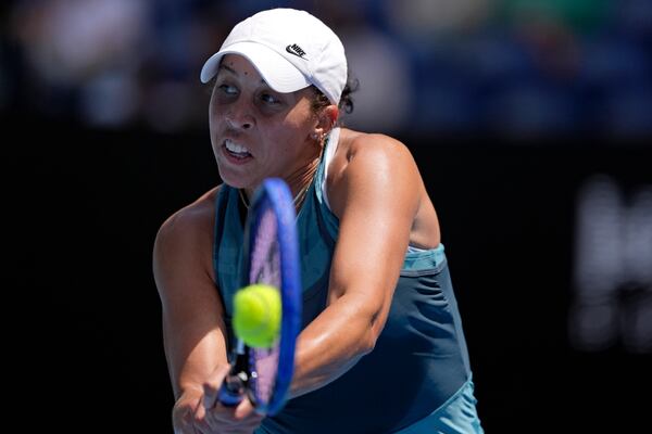 Madison Keys of the U.S. plays a backhand return to Elina Svitolina of Ukraine during their quarterfinal match at the Australian Open tennis championship in Melbourne, Australia, Wednesday, Jan. 22, 2025. (AP Photo/Ng Han Guan)