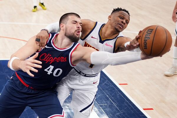 Los Angeles Clippers center Ivica Zubac, left, and Denver Nuggets guard Russell Westbrook reach for a rebound during the second half in Game 6 of an NBA basketball first-round playoff series Thursday, May 1, 2025, in Inglewood, Calif. (AP Photo/Mark J. Terrill)