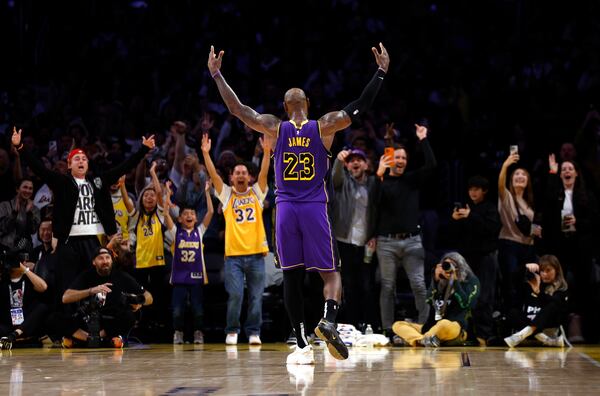 Los Angeles Lakers forward LeBron James celebrates with fans after defeating the Golden State Warriors, during an NBA basketball game Thursday, Feb. 6, 2025, in Los Angeles. (AP Photo/Kevork Djansezian)