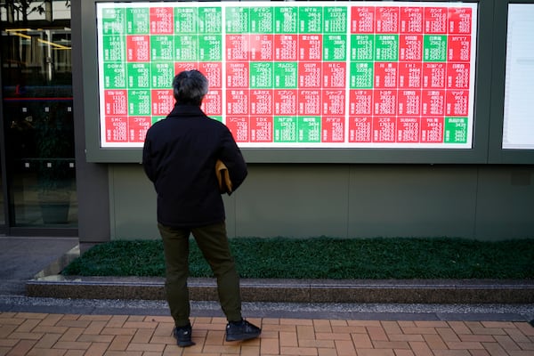 A person looks at an electronic stock board showing Japan's Nikkei index at a securities firm Monday, Dec. 23, 2024, in Tokyo. (AP Photo/Eugene Hoshiko)