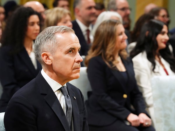 Prime minister-designate Mark Carney, left, and Chrystia Freeland look on ahead of a swearing in ceremony at Rideau Hall in Ottawa on Friday, March 14, 2025. (Sean Kilpatrick/The Canadian Press via AP)