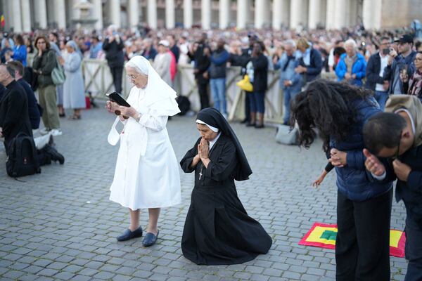 Sor Clara a nun from Peru prays during the speech of the newly elected Pope Leo XIV at the Vatican, Thursday, May 8, 2025. (AP Photo/Francisco Seco)