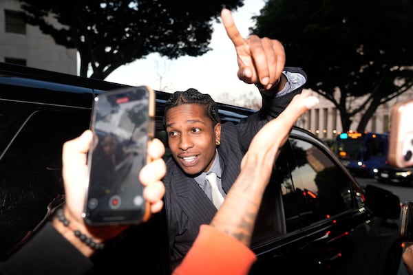 A$AP Rocky gestures out of the window of a vehicle while leaving court after he was found not guilty in his trial Tuesday, Feb. 18, 2025, in Los Angeles. (AP Photo/Damian Dovarganes)