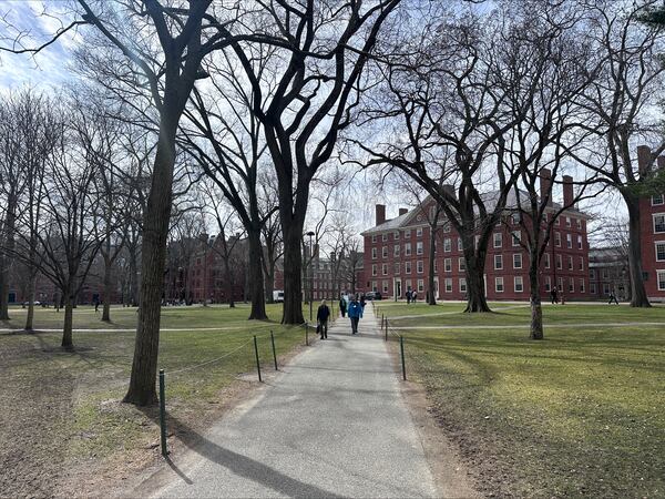 People walk through the campus of Harvard University in Cambridge, Mass., Tuesday, March 18, 2025, which announced plans to make tuition free for students of families making up to $200,00. (AP Photos/Michael Casey)