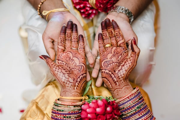 This May 2023 photo shows a bride's hands covered in mehndi in Addison Park, N.J. (Alexander Mai of Omne Amor via AP)