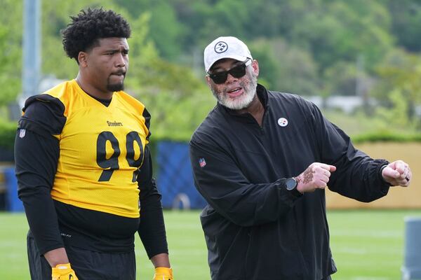 Pittsburgh Steelers first round draft pick Derrick Harmon (99) listens as defensive line coach Karl Dunbar explains a drill during the NFL football team's rookie camp in Pittsburgh, Friday, May 9, 2025. (AP Photo/Gene J. Puskar)