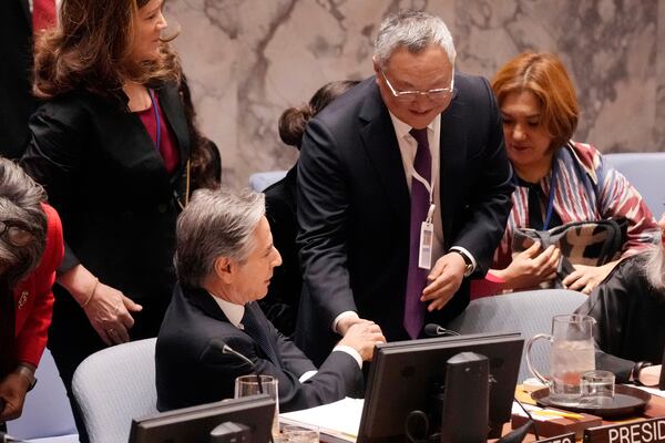 U.S. Secretary of State Antony Blinken is greeted by China's UN Ambassador Fu Cong, right, in the United Nations Security Council, Thursday, Dec. 19, 2024. (AP Photo/Richard Drew)