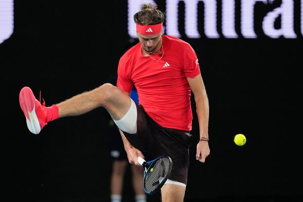 Alexander Zverev of Germany plays shot back between his legs to Lucas Pouille of France during their first round match at the Australian Open tennis championship in Melbourne, Australia, Sunday, Jan. 12, 2025. (AP Photo/Vincent Thian)