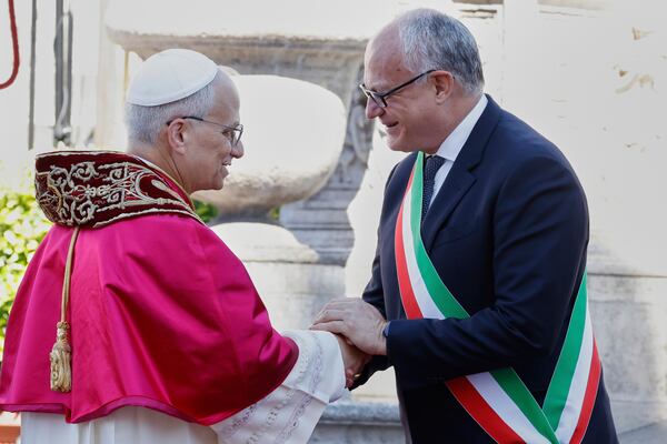 Pope Leo XIV is greeted by Rome's Mayor Roberto Gualtieri at the foot of Capitoline Hill, in Rome, Sunday, May 25, 2025. (AP Photo/Riccardo De Luca)