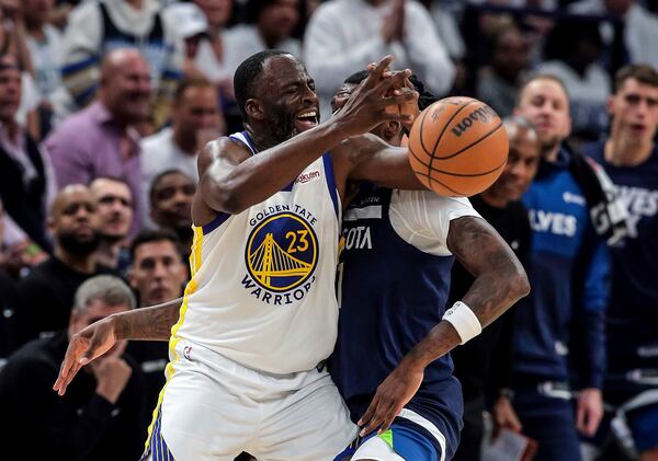 Golden State Warriors forward Draymond Green (23) is defended by Minnesota Timberwolves center/forward Naz Reid (11) and gets a technical foul for contact during the first half of Game 2 of an NBA basketball second-round playoff series Thursday, May 8, 2025, in Minneapolis. (Carlos Avila Gonzalez/San Francisco Chronicle via AP)