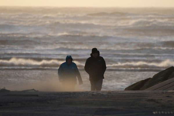 People walk on the seaside as Storm Eowyn hits the country in Blackpool, England, Friday, Jan. 24, 2025.(AP Photo/Jon Super)