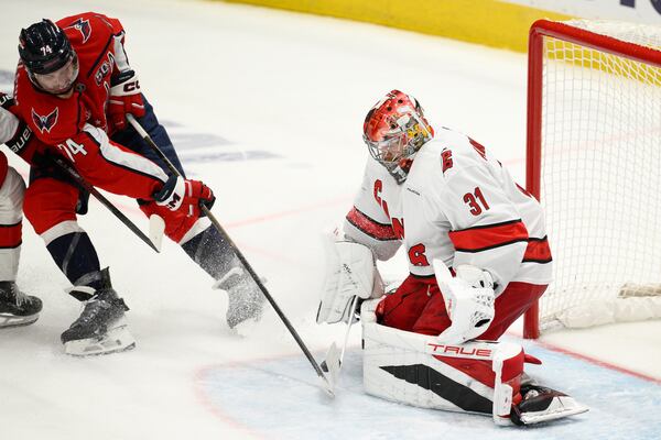 Carolina Hurricanes goaltender Frederik Andersen (31) stops the puck against Washington Capitals defenseman John Carlson (74) in the third period of Game 5 of a second-round NHL hockey playoff series Thursday, May 15, 2025, in Washington. (AP Photo/Nick Wass)