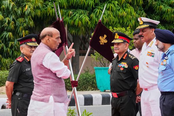 Indian Defense Minister Rajnath Singh, second left, talks to three Indian defense chiefs, Army General Upendra Dwivedi, third right, Naval Admiral Dinesh K Tripathi, second right, and Air Force Air Chief Marshal A P Singh, right, as Indian Chief of Defense Staff General Anil Chauhan, left, watches as they wait for the arrival of Japan's Defense Minister Gen Nakatani in New Delhi, India, Monday, May 5, 2025.(AP Photo/Manish Swarup)