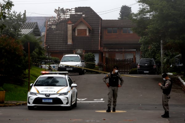 Police cordon off houses that were hit by a plane in Gramado, Rio Grande do Sul state, Brazil, Sunday, Dec. 22, 2024. (AP Photo/Mateus Bruxel, Agência RBS)